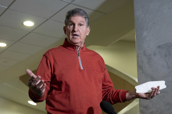 Senator Manchin responds to questions from reporters at the Capitol in Washington, January 18, 2022.