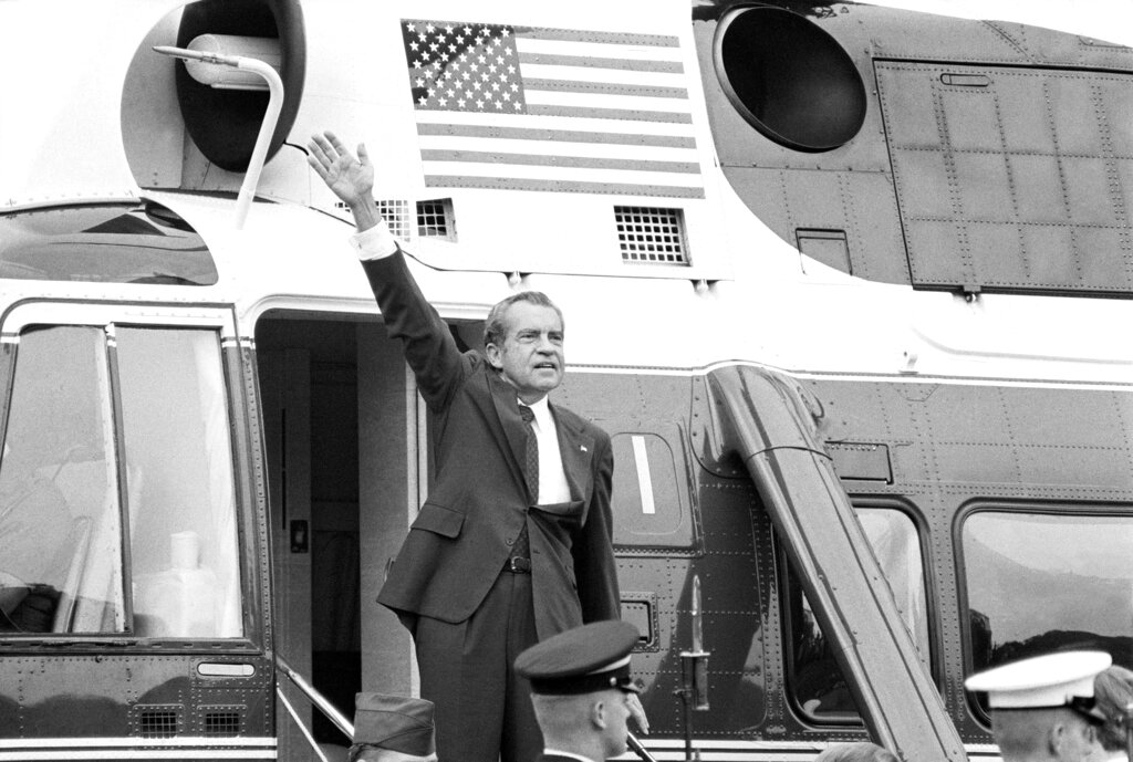 President Nixon waves goodbye from the steps of his helicopter outside the White House on August 9, 1974.