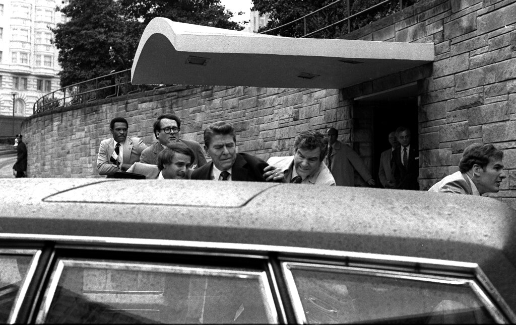 In this March 30, 1981, file photo, President Reagan is shown being shoved into his limousine by secret service agents after being shot outside a Washington hotel.