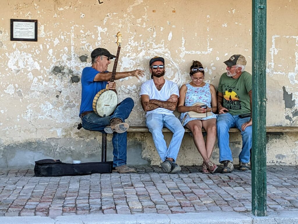 Locals gather on the porch of the Terlingua Trading Company at Terlingua, Texas.