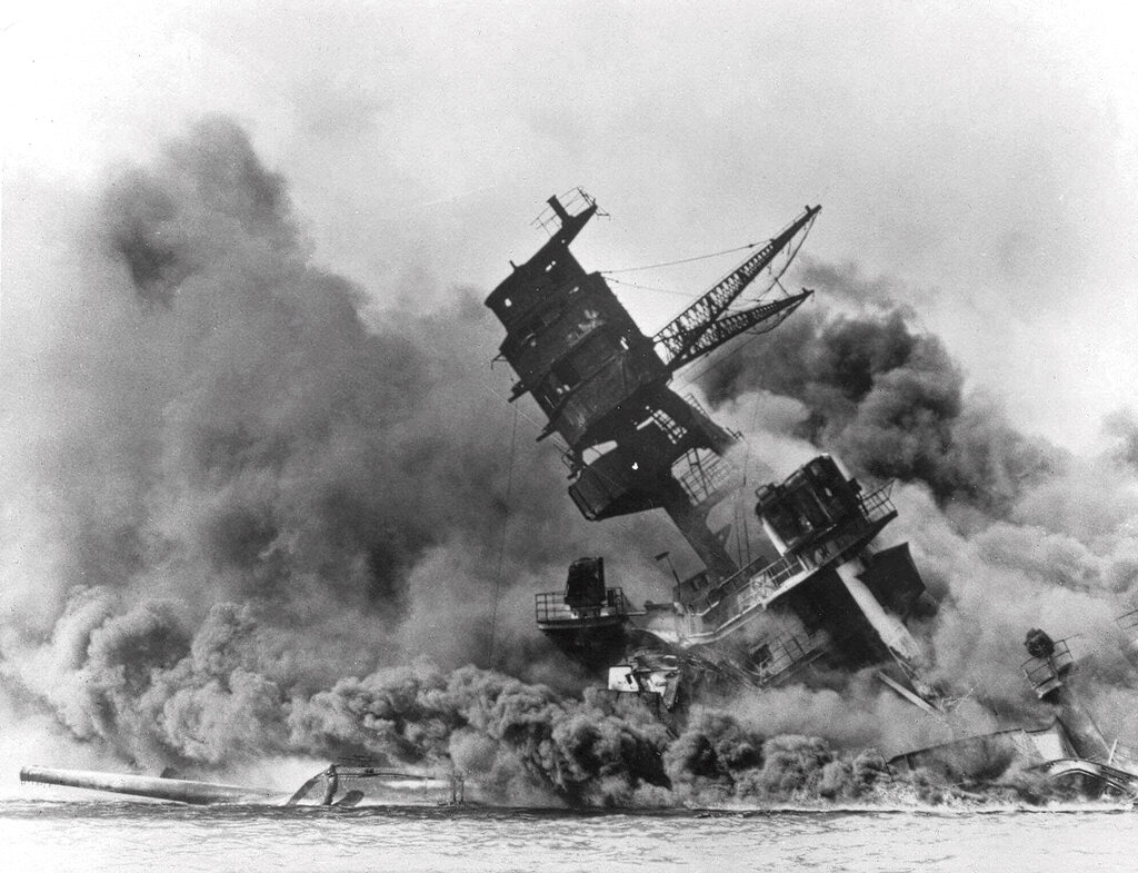 December 7, 1941, 'a date which will live in infamy,' as the battleship USS Arizona sinks during the Japanese attack on Pearl Harbor.