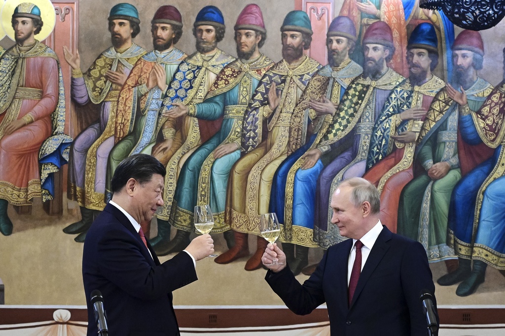Presidents Xi and Putin toast during their dinner at the Palace of the Facets, a building in the Kremlin, March 21, 2023.