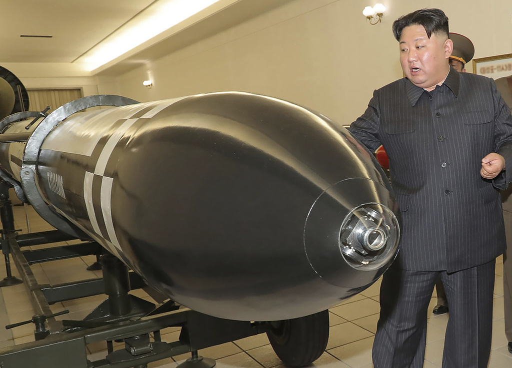 This photo provided on Tuesday, March 28, 2023, by the North Korean government, North Korean leader Kim Jong Un, rear, visits a hall displayed what appeared to be various types of warheads designed to be mounted on missiles or rocket launchers on March 27, 2023, in undisclosed location, North Korea. Independent journalists were not given access to cover the event depicted in this image distributed by the North Korean government. The content of this image is as provided and cannot be independently verified.