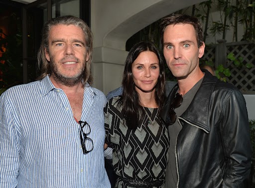 Author Kevin Morris, actress Courteney Cox, and songwriter Johnny McDaid attend a book release party for Morris's 'White Man's Problem' on June 3, 2014, at Los Angeles.