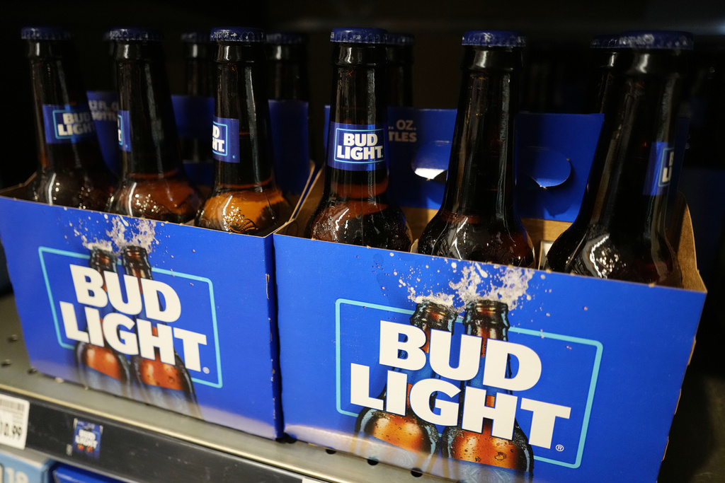 FILE - Bottles of Bud Light beer sit on a shelf at a grocery store on April 25, 2023, in Glenview, Ill. Bud Light's parent company said Thursday, May 4, that it will triple its marketing spending in the U.S. this summer as it tries to boost sales that plummeted after the brand partnered with a transgender influencer. (