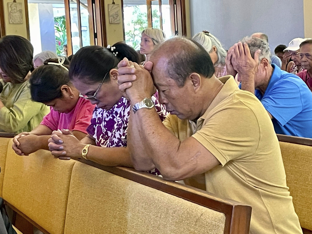 Parishioners attend Mass at Sacred Hearts Mission Church on August 13, 2023, at Kapalua, Hawaii.