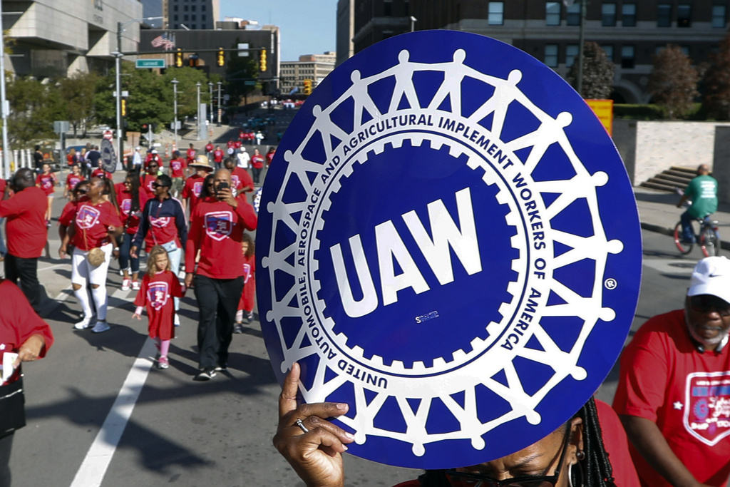 FILE - United Auto Workers members walk in the Labor Day parade in Detroit, Sept. 2, 2019. Auto workers are voting overwhelmingly to give union leaders the authority to call strikes against Detroit car companies if a contract agreement isn’t reached. The United Auto Workers union said Friday, Aug. 25, 2023, that results are still being tallied, but so far 97% have voted in favor of authorizing one or more strikes against Stellantis, General Motors and Ford. (