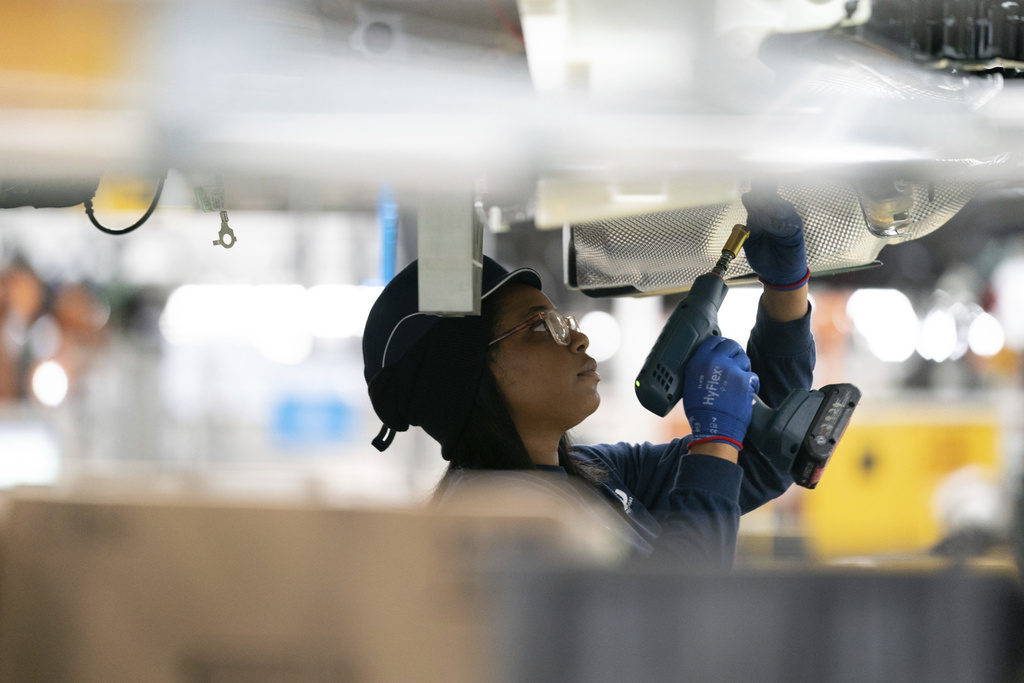 An employee works on the assembly line at the BMW Spartanburg plant at Greer, South Carolina, October 19, 2022.