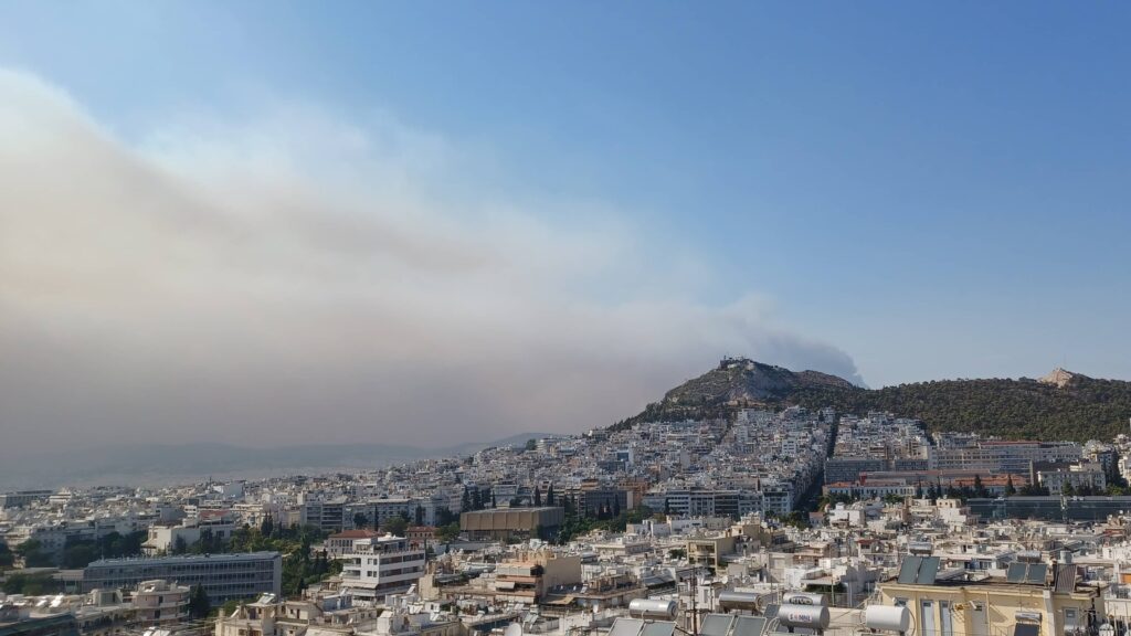 Smoke from a forest fire this week rises over downtown Athens.