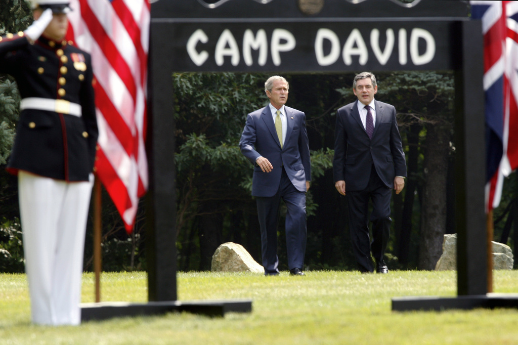 FILE - President George W. Bush, left, and British Prime Minister Gordon Brown walk to a joint press availability at Camp David, Md., July 30, 2007. (