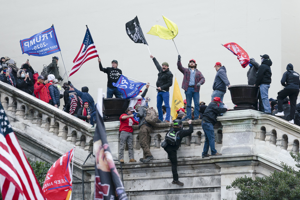 FILE - Rioters wave flags on the West Front of the U.S. Capitol in Washington on Jan. 6, 2021.