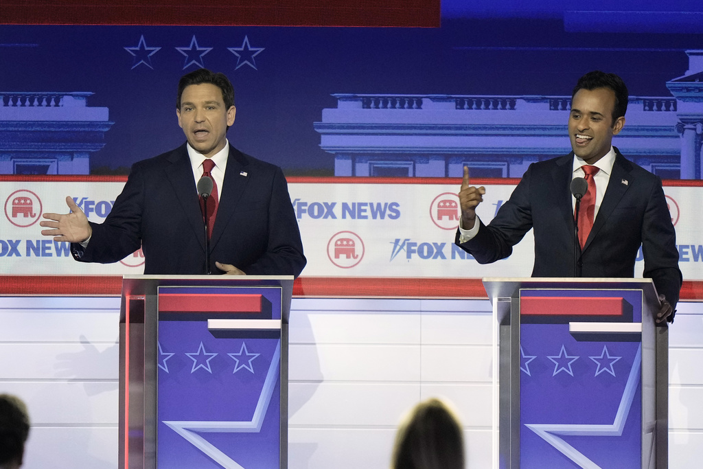 Florida Gov. Ron DeSantis and businessman Vivek Ramaswamy speak at the same time during a Republican presidential primary debate hosted by FOX News Channel Wednesday, Aug. 23, 2023, in Milwaukee.