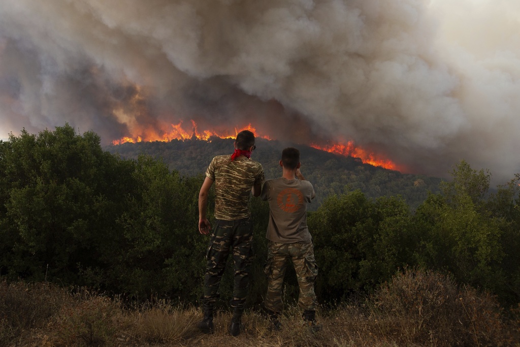 Flames burn a forest during wildfires near the village of Sykorrahi, near Alexandroupolis town, in the northeastern Evros region, Greece, Wednesday, Aug. 23, 2023. Advancing flames are devouring forests and homes in Greece as wildfires that have killed 20 people are raging.