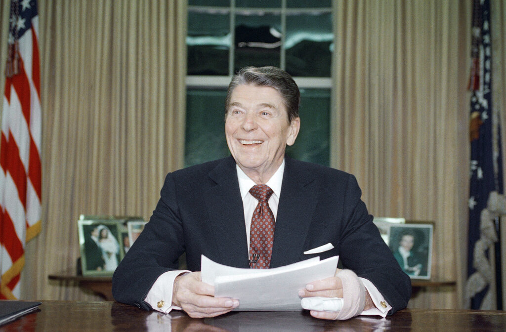 President Ronald Reagan poses for photographers in the Oval Office of the White House, Jan. 11, 1989 after delivering a televised farewell address to the nation. In the parting address, Reagan said that during his eight years in office, "we meant to change a nation and instead we changed a world." (