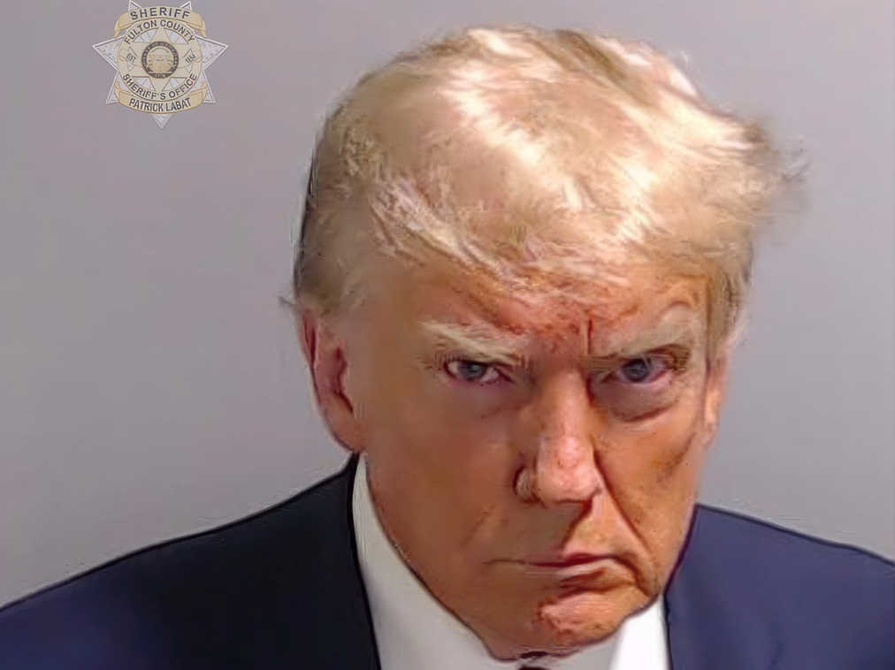 This booking photo provided by Fulton County Sheriff's Office, shows former President Donald Trump on Thursday, Aug. 24, 2023, after he surrendered and was booked at the Fulton County Jail in Atlanta. Trump is accused by District Attorney Fani Willis of scheming to subvert the will of Georgia voters in a desperate bid to keep Joe Biden out of the White House. (Fulton County Sheriff's Office via AP)