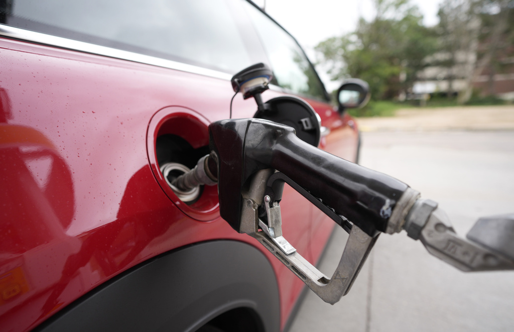 A motorist fills up the tank of a vehicle at a Shell station at Englewood, Colorado, on July 5, 2023.