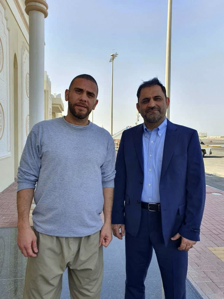 In this photo released by Nour News on Monday, Sept. 18, 2023, Iranians Reza Sarhangpour Kafrani, right, and Mehrdad Moein Ansari pose at Doha airport in Qatar after being released from prison in the United States in a prisoner swap with Iran. Officials said five prisoners sought by the U.S. in a trade with Iran flew out of Tehran on Monday, part of a deal that saw nearly $6 billion in Iranian assets unfrozen. (