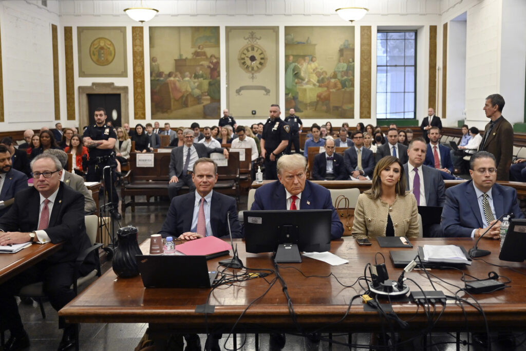 President Trump sits between his lawyers Christopher Kise, left, and Alina Habba during his civil fraud trial at the State Supreme Court building at New York, October 4, 2023.