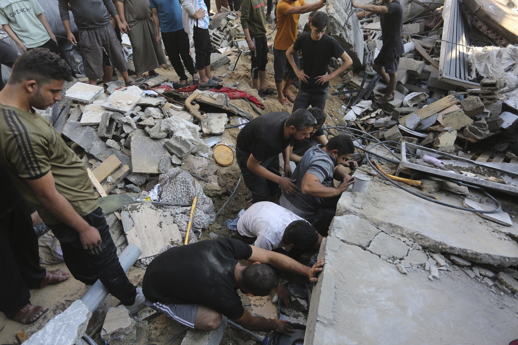 Palestinians look for survivors after an Israeli strike in Rafah, Gaza Strip, Tuesday, Oct. 31, 2023.