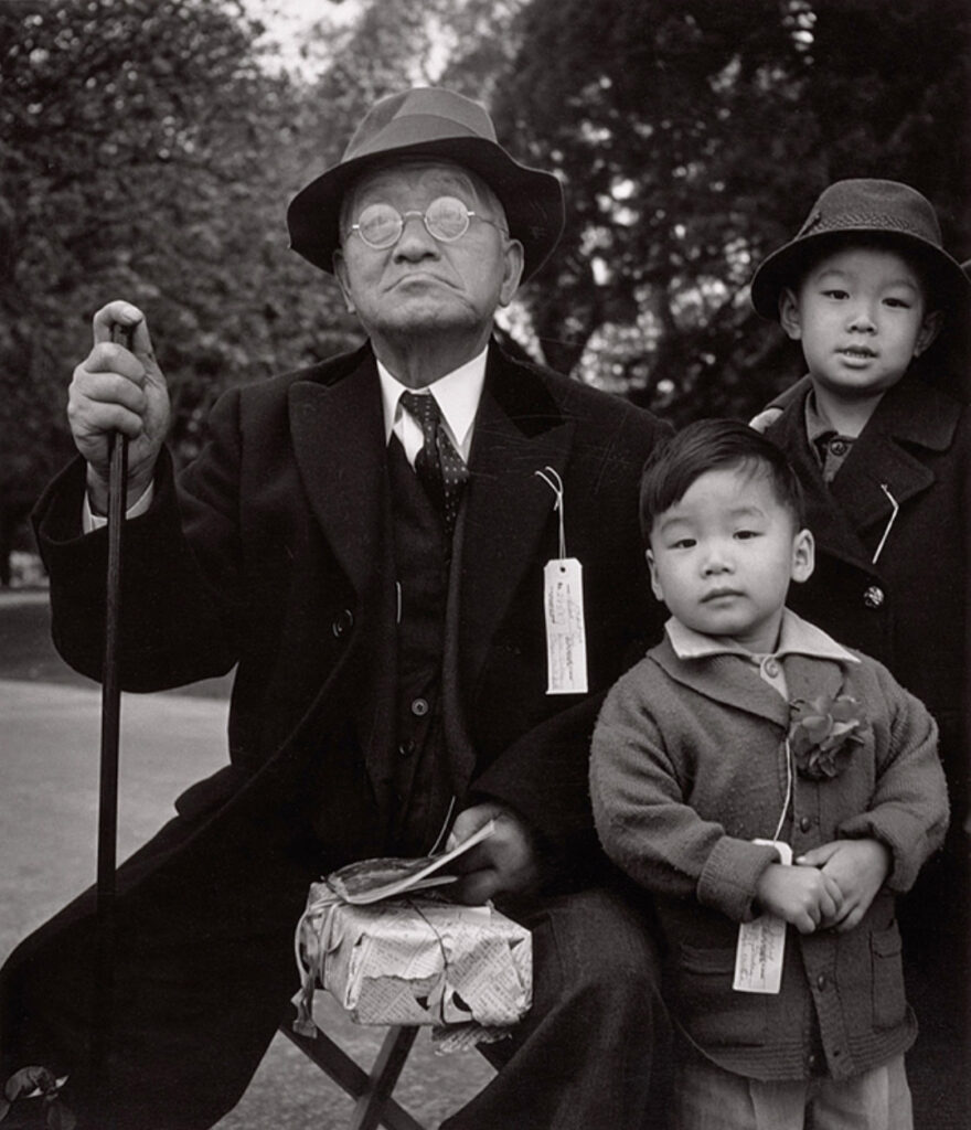 Dorothea Lange Grandfather and Grandchildren Awaiting Evacuation Bus, Hayward, California , 1942 gelatin silver print image: 26.4 x 22.7 cm (10 3/8 x 8 15/16 in.) sheet: 35.4 x 27.8 cm (13 15/16 x 10 15/16 in.) frame (outside): 20 3/4 x 16 7/8 in. The Nelson-Atkins Museum of Art, Kansas City, Missouri (Gift of Hallmark Cards, Inc.) 2005.27.4215