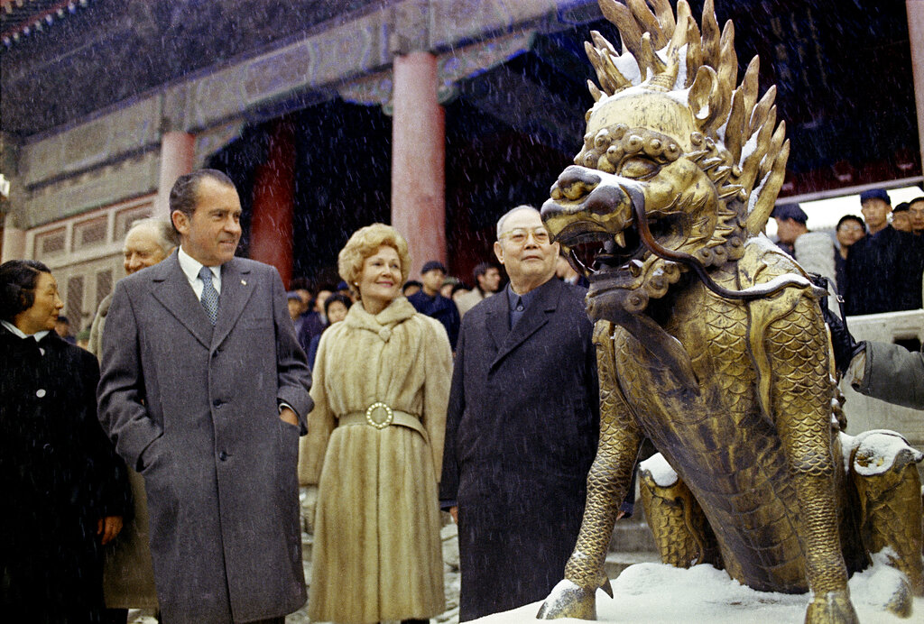 FILE - Then U.S. President Richard Nixon and then first lady Pat Nixon looks at a sculpture depicting a mythical beast on the palace grounds of Beijing's Forbidden City as heavy snow falls on Feb. 25, 1972. At the height of the Cold War, U.S. President Richard Nixon flew into communist China's center of power for a visit that over time would transform U.S.-China relations and China's position in the world in ways that were unimaginable at the time.