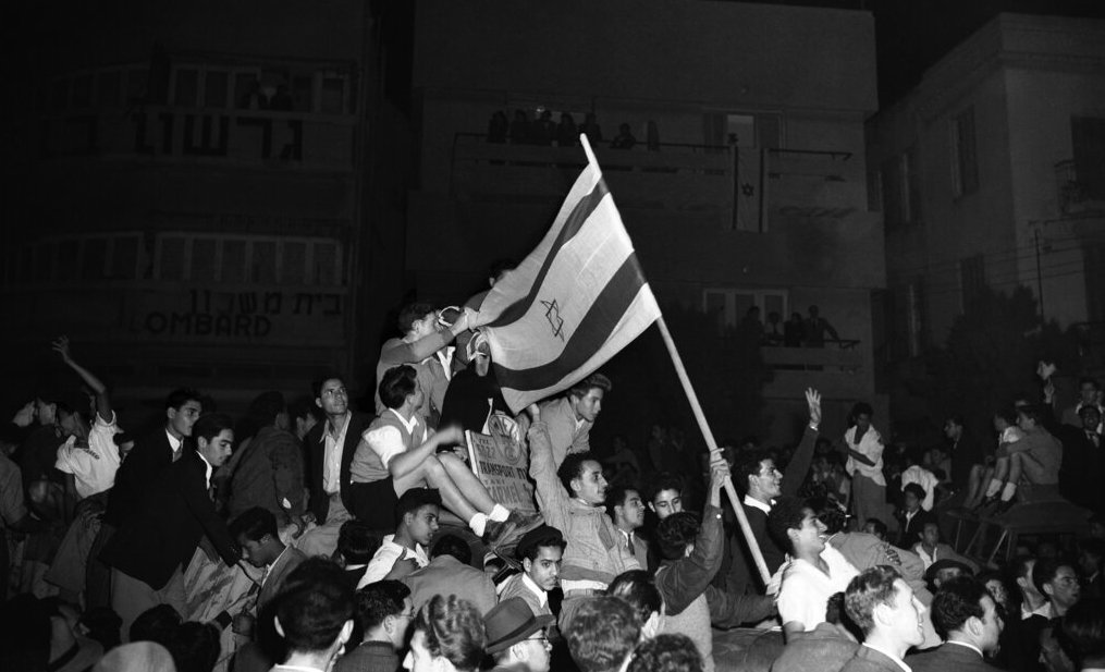 Some of the thousands of Jews celebrate in Tel Aviv as they listen to the broadcast on the United Nations announcement for the plan for partition with the Jewish state on November 30, 1947 in the new Jewish state. Some people wave the Jewish National flag. The United Nations resolution passed by the General Assembly would have partitioned the territory of Palestine into Jewish and Arab states, with greater Jerusalem area, including Bethlehem, coming under international control. (