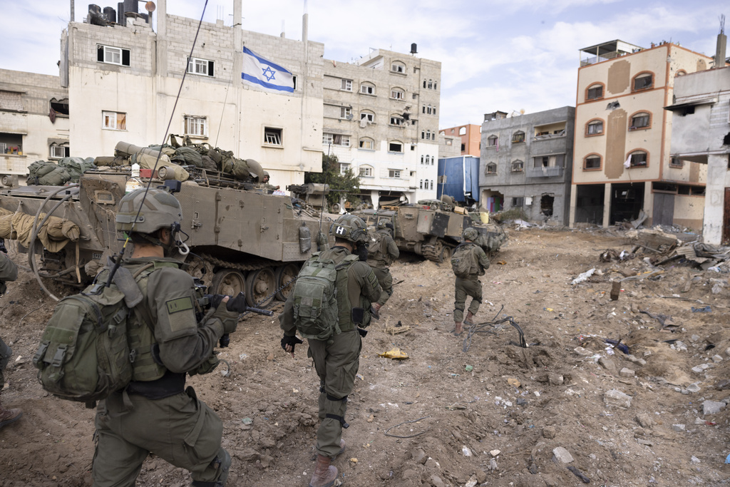 Israeli soldiers take part in a ground operation in Gaza City's Shijaiyah neighborhood, Friday, Dec. 8, 2023. The army is battling Palestinian militants across Gaza in the war ignited by Hamas' Oct. 7 attack into Israel. (