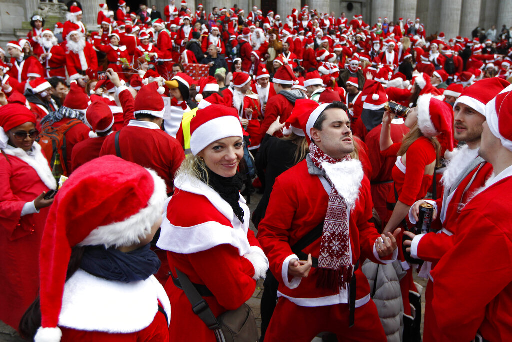 Revellers dressed up in Santa outfits gather at St Paul's Cathedral in London during a Santacon festival parade through the streets of London, Saturday, Dec. 15, 2012.