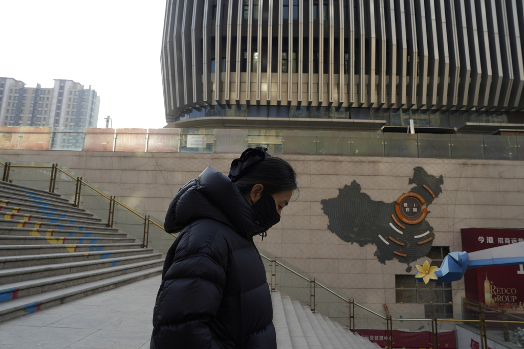 A woman walks through a partially shuttered Evergrande commercial complex at Beijing on January 29, 2024.
