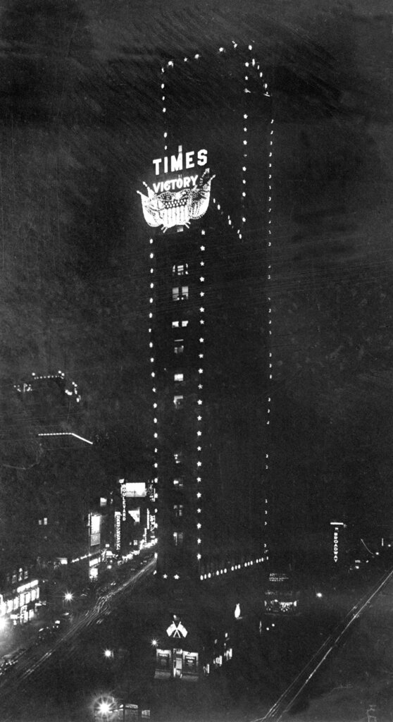 The New York Times building at One Times Square in New York is seen decorated with a Victory emblem, 1918.