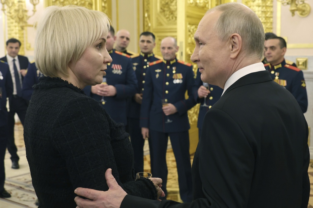 Russian President Vladimir Putin, speaks to Maria Kostyuk, mother of Andrei Kovtun who was posthumously awarded the title of Hero of Russia, after a ceremony to present Gold Star medals to Heroes of Russia on the eve of Heroes of the Fatherland Day at the St. George Hall of the Grand Kremlin Palace, in Moscow, Russia, Friday, Dec. 8, 2023.