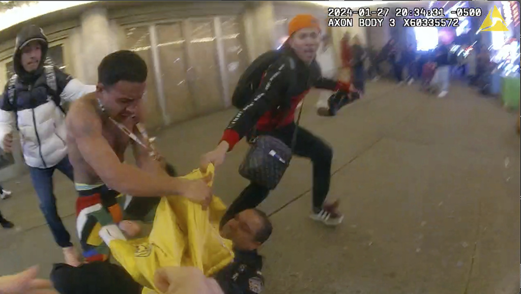 This image from body cam video provided by the Office of the Manhattan District Attorney, Thursday, Feb. 8, 2024, shows the brawl between New York City Police Department officers and migrants in Times Square, Jan. 27, 2024. Manhattan D.A. Alvin Bragg announced six additional indictments of men allegedly involved in a brawl with police officers in Times Square, but he said investigators were still working to identify several suspects and their exact role in the frenzy.