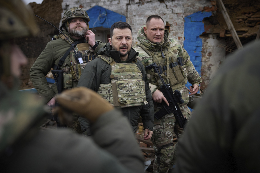 In this photo provided by the Ukrainian Presidential Press Office, Ukrainian President Volodymyr Zelenskyy, centre, during his visit to Zaporizhzhia region, the site of fierce battles with the Russian troops in Ukraine, Sunday, Feb. 4, 2024.