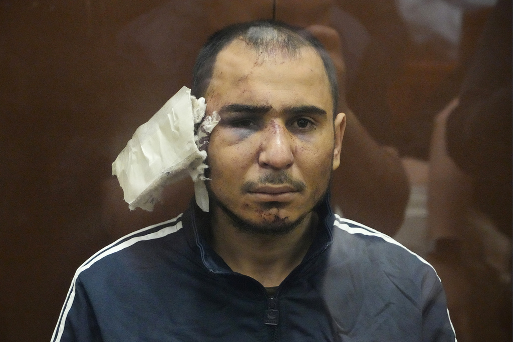 Saidakrami Murodali Rachabalizoda, a suspect in the Crocus City Hall shooting on Friday, sits in a glass cage in the Basmanny District Court in Moscow, Russia, Sunday, March 24, 2024.
