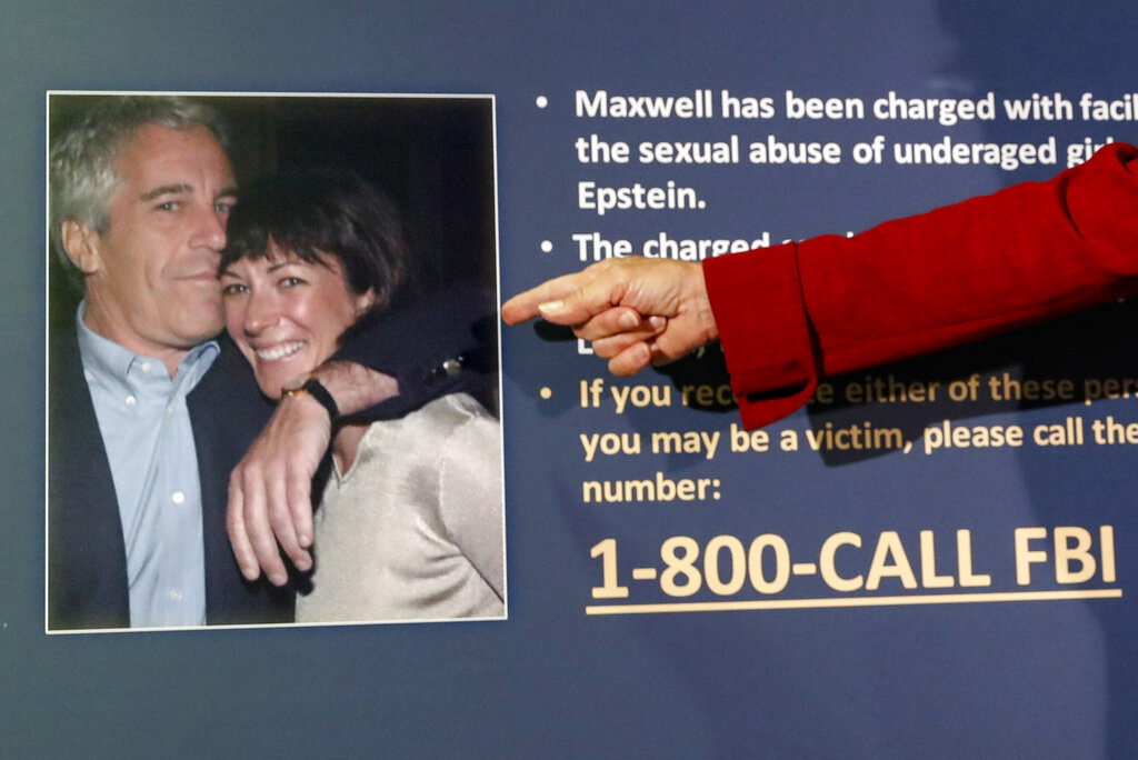 FILE - In this July 2, 2020, file photo, Audrey Strauss, acting U.S. attorney for the Southern District of New York, points to a photo of Jeffrey Epstein and Ghislaine Maxwell during a news conference in New York. On Tuesday, Nov. 24, one of Maxwell's attorneys said that her client is awakened every 15 minutes in jail while she sleeps to ensure she's breathing.