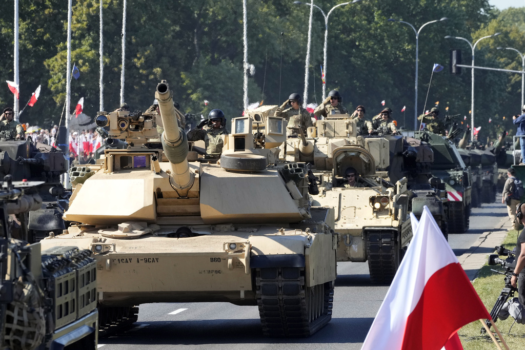 U.S.-made Abrams tanks purchased by Poland take part in a massive military parade to celebrate the Polish Army Day, commemorating the 1920 battle in which Polish troops defeated advancing Bolshevik forces, in Warsaw, Poland, Tuesday, Aug. 15, 2023. Poland is holding a military parade to showcase its state-of-the-art weapons and defense systems, as war rages across its southeastern border in neighboring Ukraine and ahead of parliamentary elections scheduled for Oct. 15.
