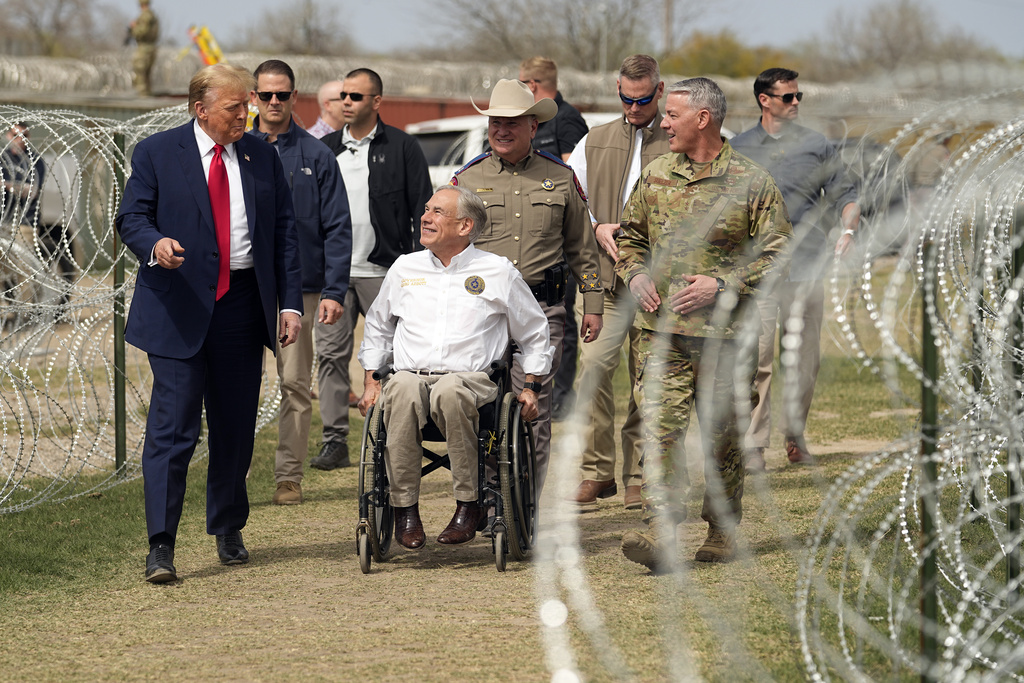 Republican presidential candidate former President Donald Trump talks with Texas Gov. Greg Abbott during a visit to the U.S.-Mexico border, Thursday, Feb. 29, 2024, in Eagle Pass, Texas.