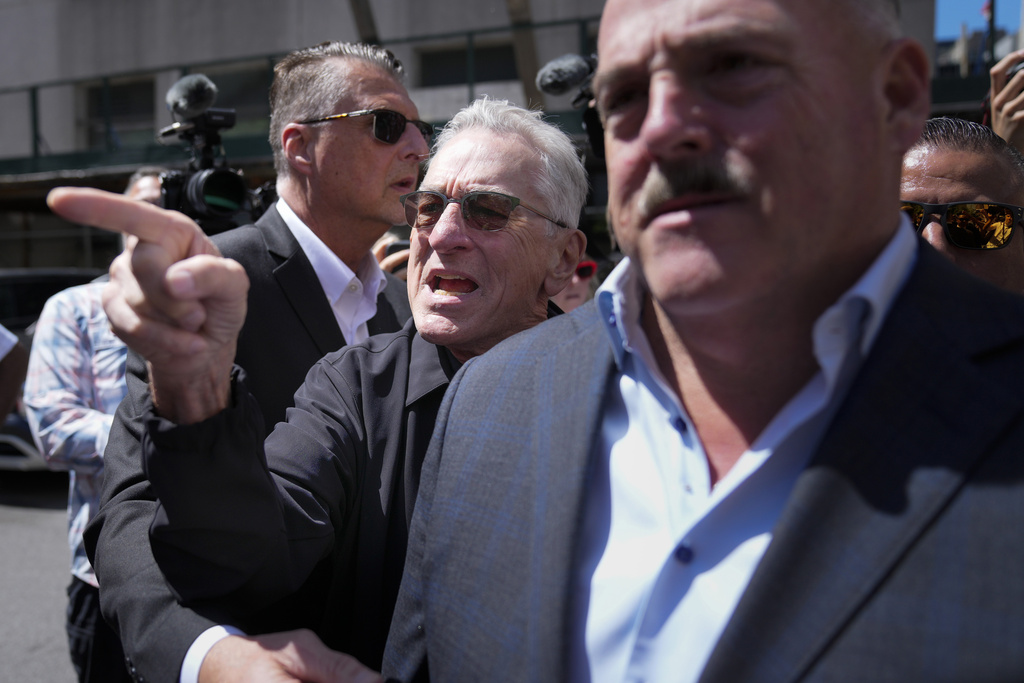 Actor Robert De Niro argues with a Trump supporter after speaking to reporters in support of President Biden across the street from Trump's criminal trial in New York, Tuesday, May 28, 2024.