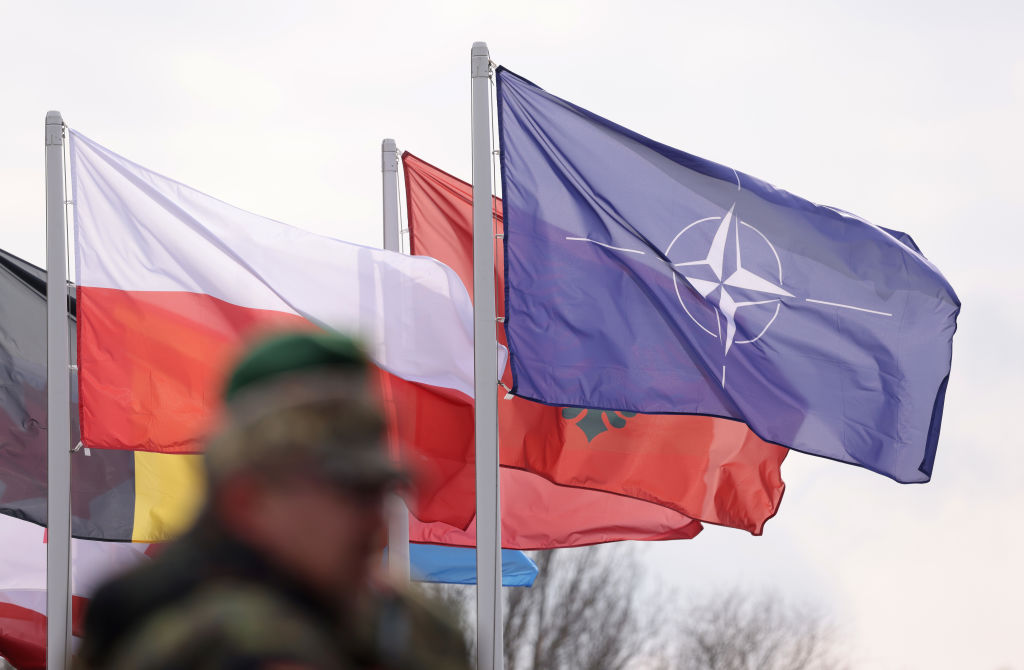 GNIEW, POLAND - MARCH 04: The flag of the NATO military alliance flies with other NATO members nations during the Vistula River crossing of the NATO Dragon 24 military exercise on March 04, 2024 near Gniew, Poland. Dragon 24 is involving troops from 10 different nations and is part of Steadfast Defender 2024, an ongoing set of NATO military manoeuvres across Europe that is involving 90,000 troops.