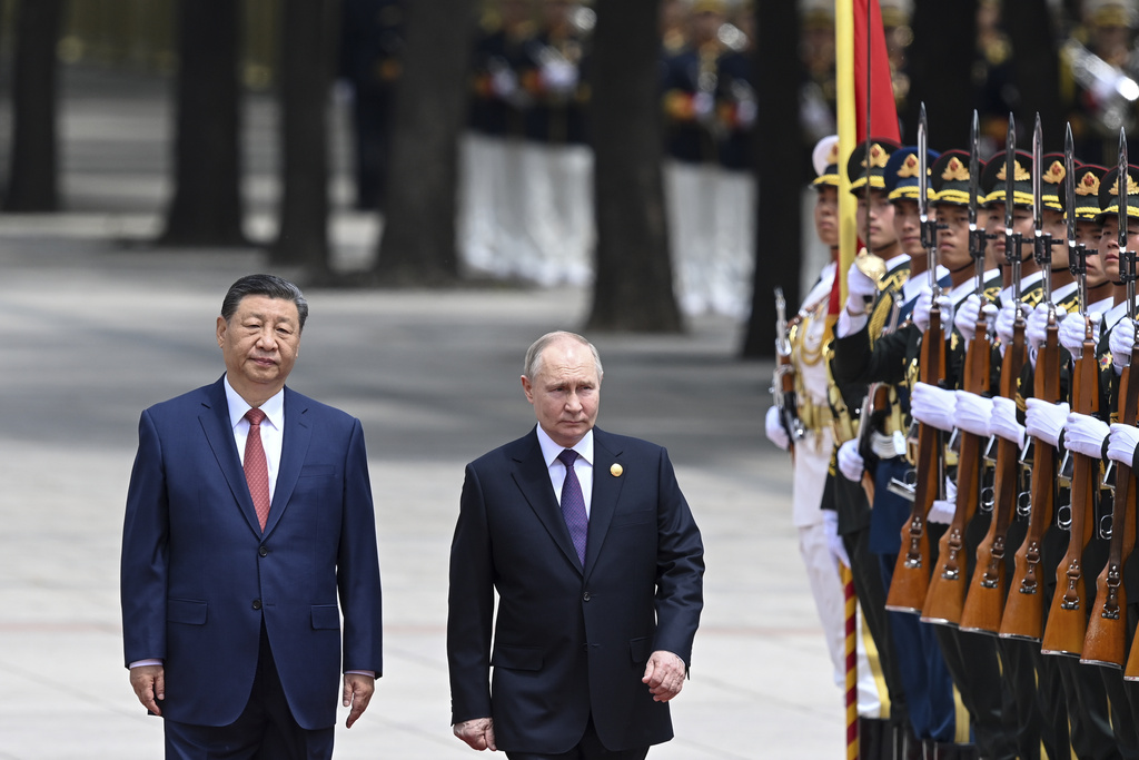 Chinese President Xi Jinping, left, and Russian President Vladimir Putin review the honor guard during an official welcome ceremony in Beijing, China, Thursday, May 16, 2024.
