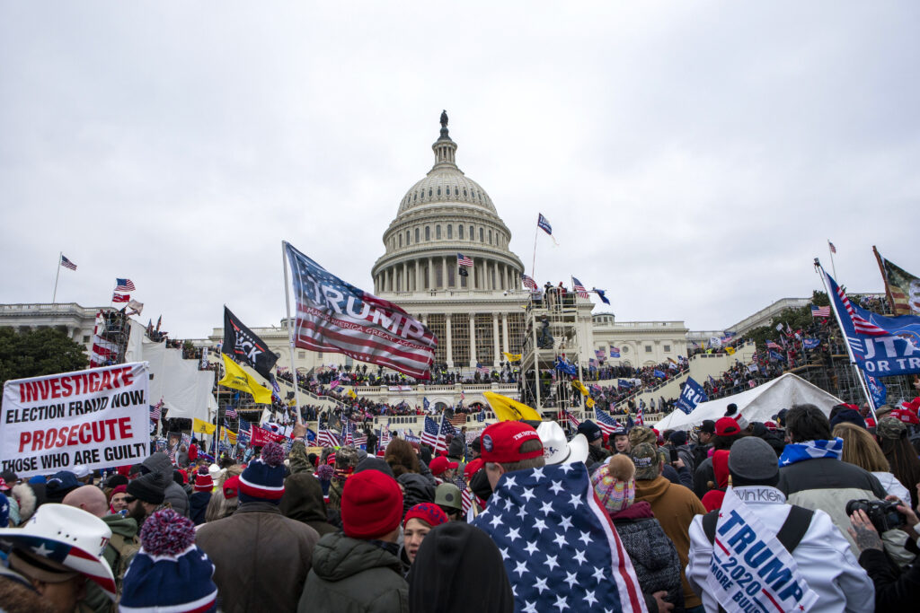 FILE - Rioters loyal to President Donald Trump rally at the U.S. Capitol in Washington, Jan. 6, 2021. Retired NASCAR driver Tighe Scott, his adult son and two other Pennsylvania men are facing felony charges stemming from confrontations with police during the Jan. 6, 2021, siege on the U.S. Capitol.