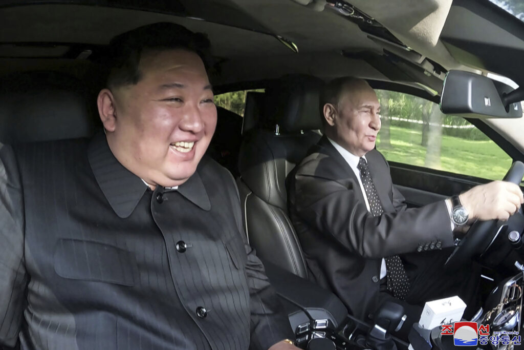 In this photo provided by the North Korean government, Russia's President Vladimir Putin, right, drives a car with North Korean leader Kim Jong Un sitting in front passenger seat at a garden of the Kumsusan State Guest House in Pyongyang, North Korea Wednesday, June 19, 2024. Independent journalists were not given access to cover the event depicted in this image distributed by the North Korean government. The content of this image is as provided and cannot be independently verified. Korean language watermark on image as provided by source reads: 