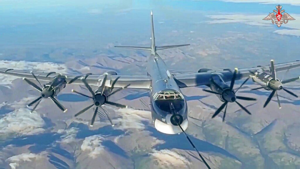 In this photo taken from video released by Russian Defense Ministry Press Service on Thursday, July 25, 2024, A Tu-95 strategic bomber of the Russian air force is refueled in the air during a join Russia-China air patrol.