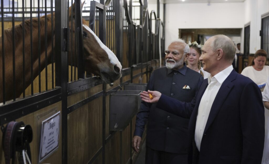 Russian President Vladimir Putin, right, and Indian Prime Minister Narendra Modi visit a stable during an informal meeting at Novo-Ogaryovo residence, outside Moscow, Russia, Monday, July 8, 2024.