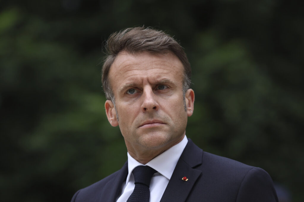 FILE - French President Emmanuel Macron reviews troops that will take part to the Bastille Day parade in Paris, on July 2, 2024. In his first public declaration since Sunday's legislative elections result, French President Emmanuel Macron said Wednesday he will give time to the country's different political parties to build a "Republican" majority at the National Assembly, before he can decide on a Prime Minister.