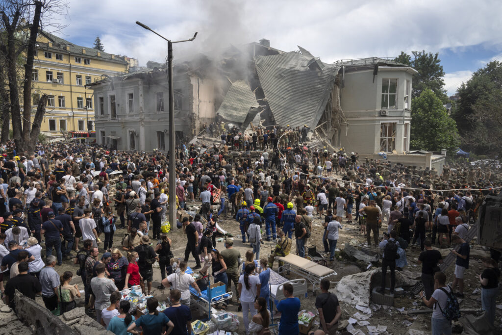 Rescuers and volunteers clean up the rubble and search victims after Russian missile hit the country's main children hospital Okhmadit during massive missile attack on many Ukrainian cities in Kyiv, Ukraine, Monday, July 8, 2024. A major Russian missile attack across Ukraine killed at least 20 people and injured more than 50 on Monday, officials said, with one missile striking a large children’s hospital in the capital, Kyiv, where emergency crews searched rubble for casualties.