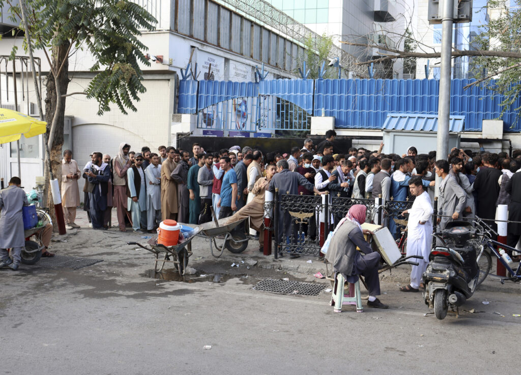 Afghans wait in long lines for hours to try to withdraw money, in front of Bank in Kabul, Afghanistan, Monday, Aug. 30, 2021. The Taliban have limited weekly withdrawals to $200.