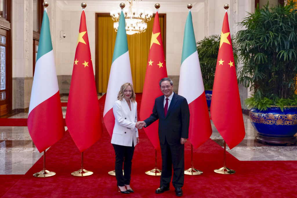 Italy's Prime Minister Giorgia Meloni shakes hands with Chinese Premier Li Qiang in Beijing, Sunday, July 28, 2024, ahead of a forum with Italian and Chinese business leaders. Meloni is on an official visit to China this week to try to reset relations at a time of both fears of a trade war with the European Union and continued interest in attracting Chinese investment in auto manufacturing and other sectors.