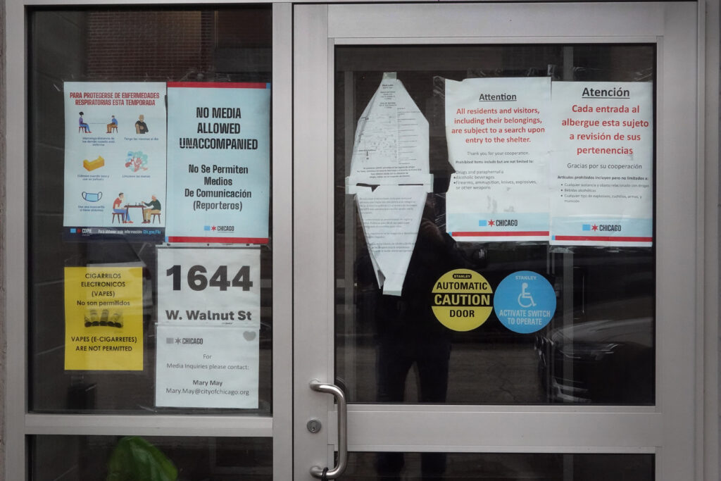 Signs are posted at the entrance of a migrant shelter at the West Loop neighborhood on January 30, 2024 at Chicago, Illinois.