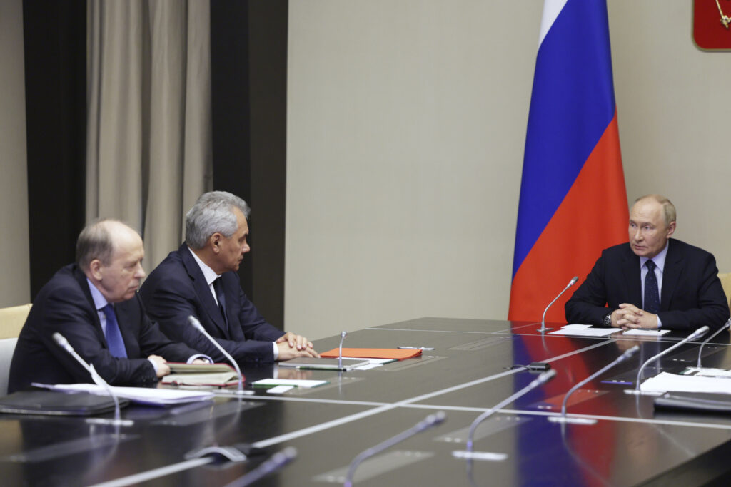 Russian President Vladimir Putin, right, chairs a meeting with Federal Security Service Chief Alexander Bortnikov, left, and Security Council Secretary Sergei Shoigu, second left, on the situation in Kursk region, where Ukrainian armed forces attempted an offensive to seize territory at the Novo-Ogaryovo state residence, outside Moscow, Russia on Wednesday, Aug. 7, 2024. (